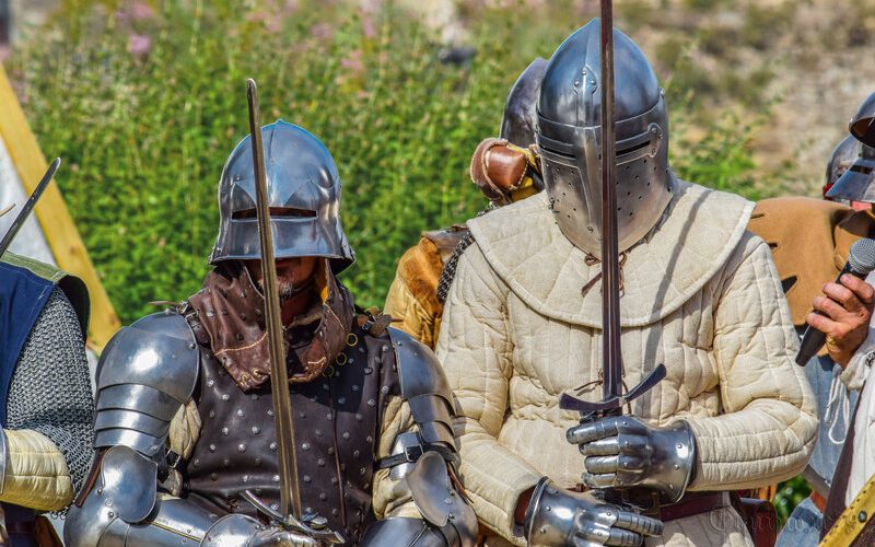 Photo of two knights in armor holding their swords